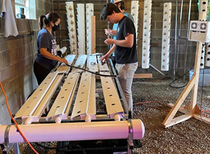 students preparing aquaponics equipment