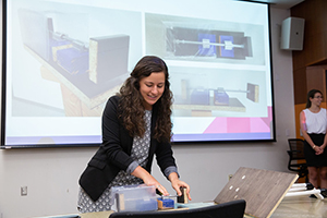 summer undergraduate research participant showing equipment during lecture