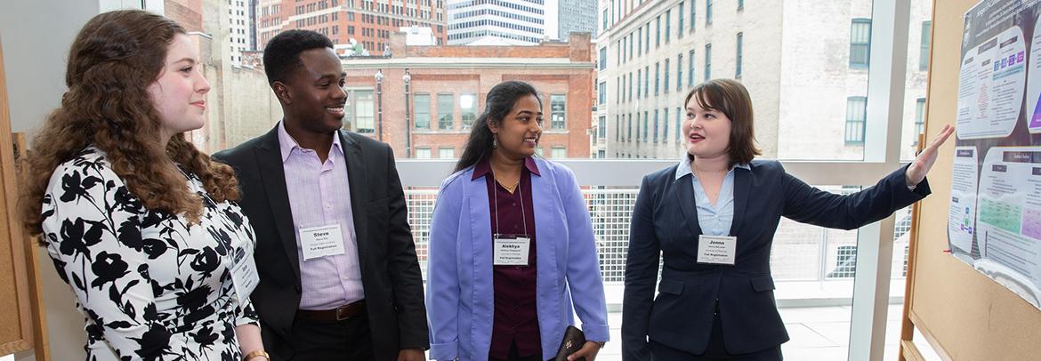 student presenting research poster to peers at Engineering Sustainability Conference