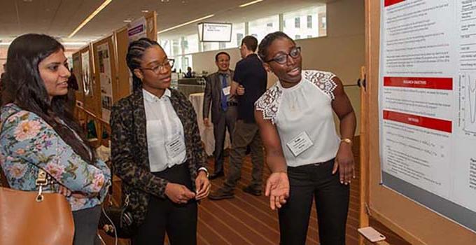 student presenting research poster at Sustainability Conference