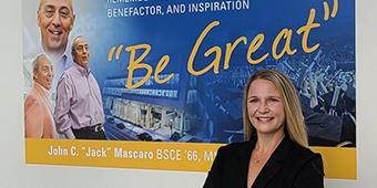 Melissa Bilec in front of founder's image banner