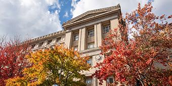 Old Engineering Building on Pitt campus with fall foliage in foreground