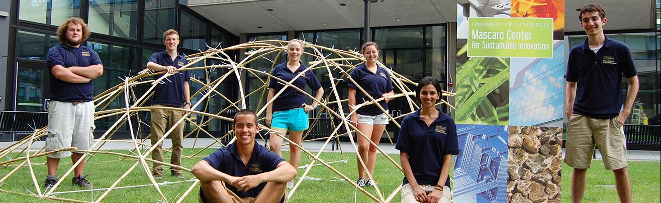 students posing with bamboo dome construction
